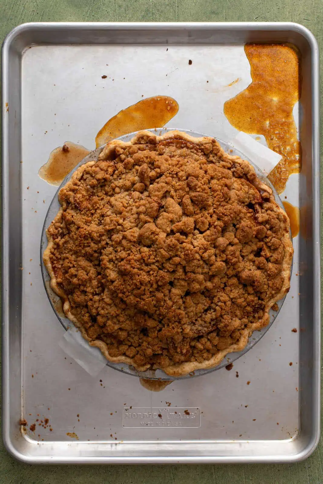 Baked dutch apple pie on a rimmed baking sheet.