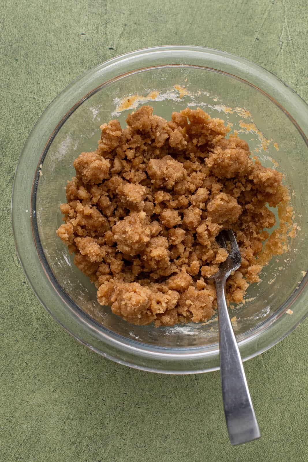 Crumb topping for dutch apple pie mixed in a glass bowl.