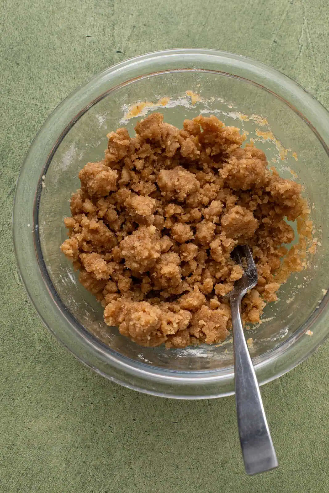Crumb topping for dutch apple pie mixed in a glass bowl.
