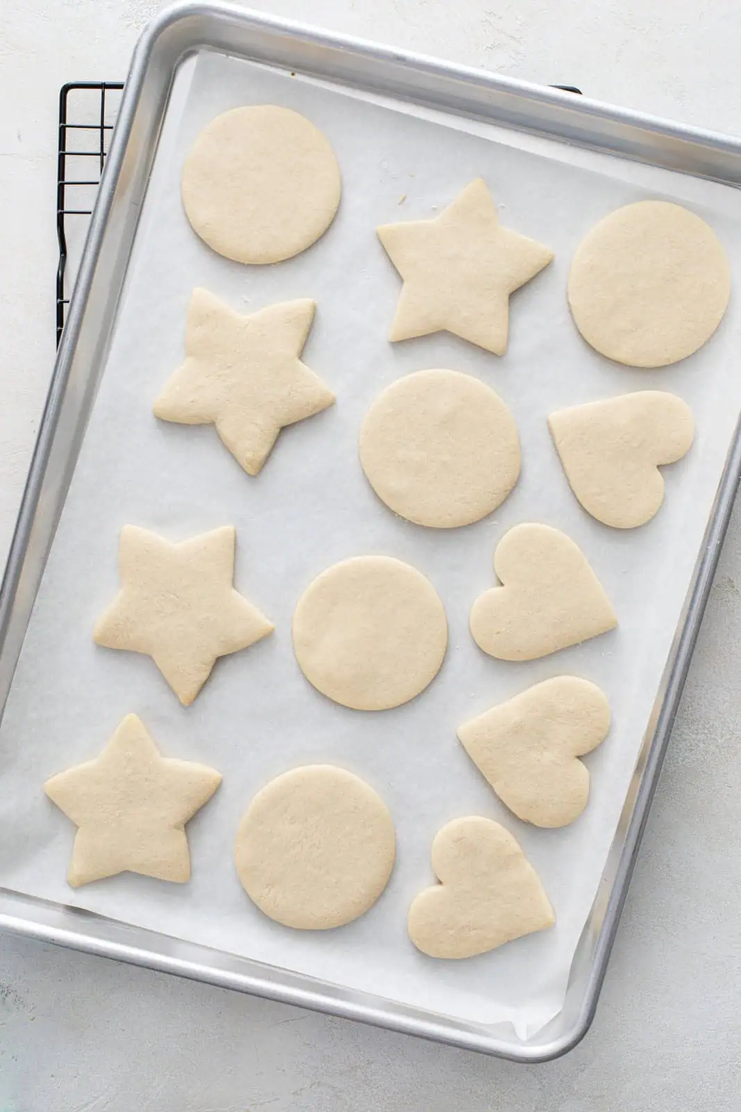 Baked no chill sugar cookies on a parchment-lined baking sheet.