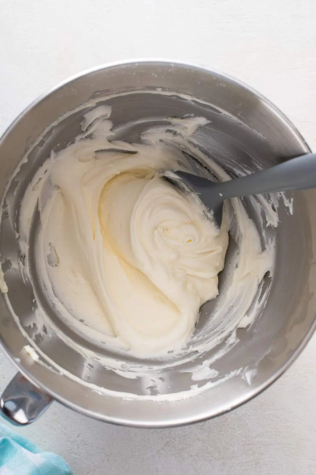 Buttercream icing for sugar cookies in a metal bowl.