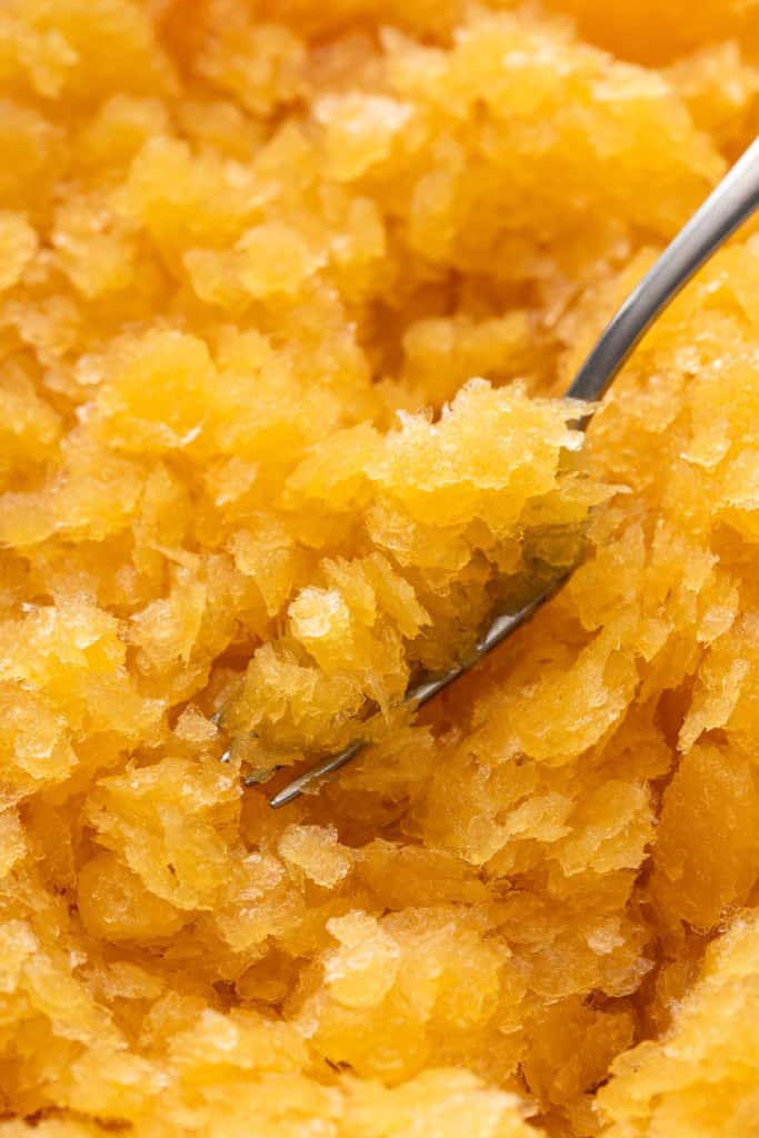 Close up of a fork scraping bourbon slush to show the texture.