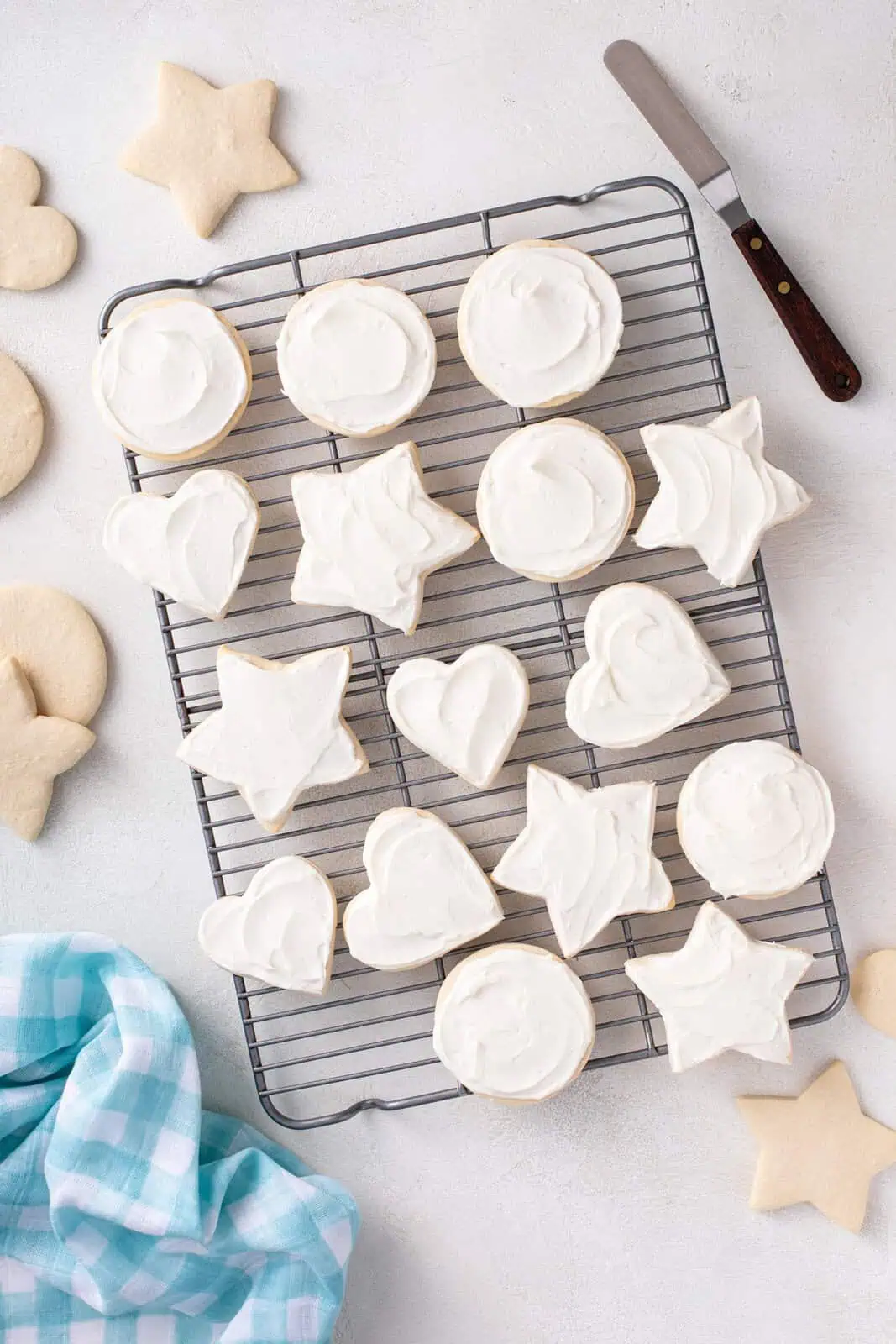 Overhead view of iced no chill sugar cookies on a wire rack.