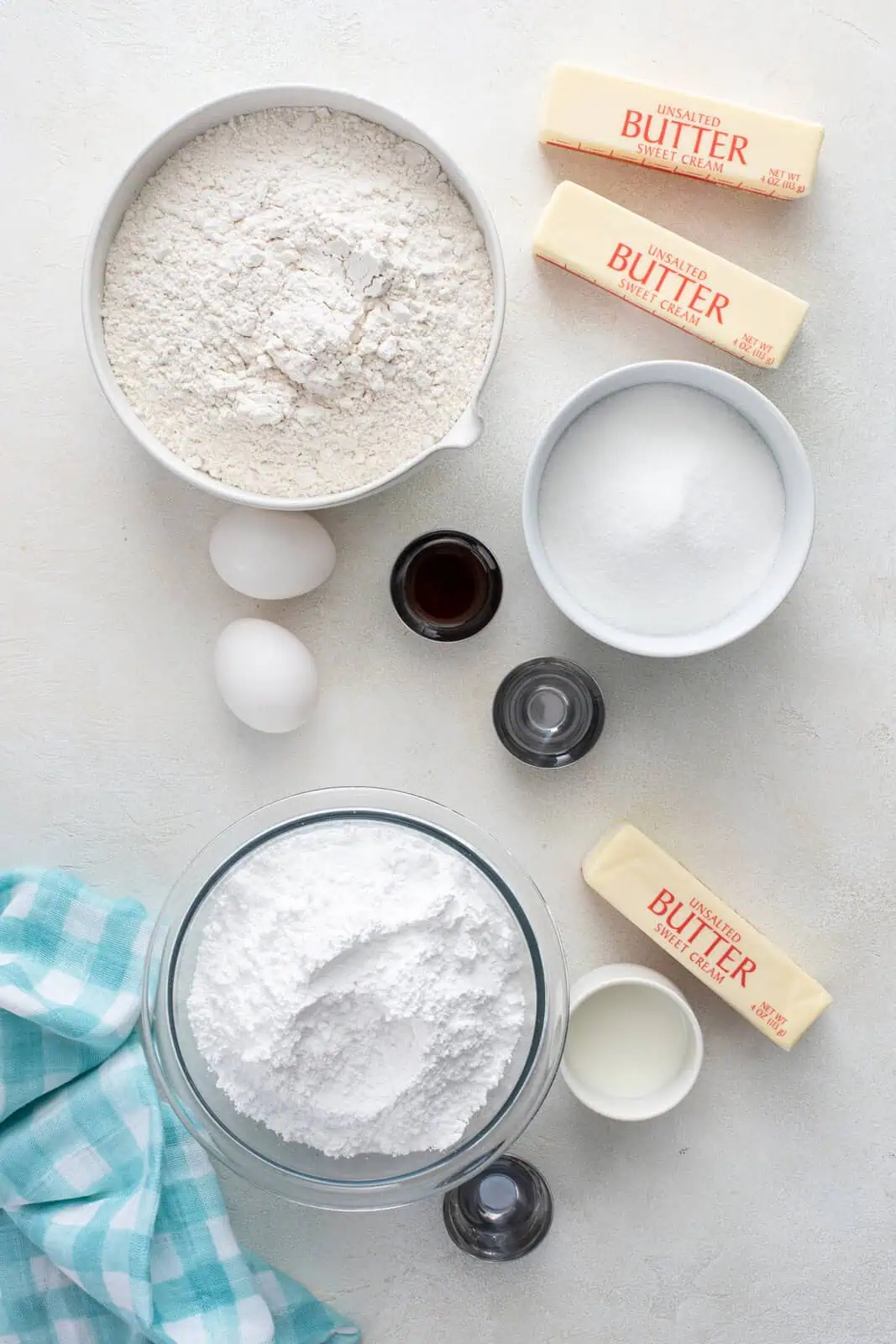 Ingredients for no chill sugar cookies arranged on a light-colored countertop.