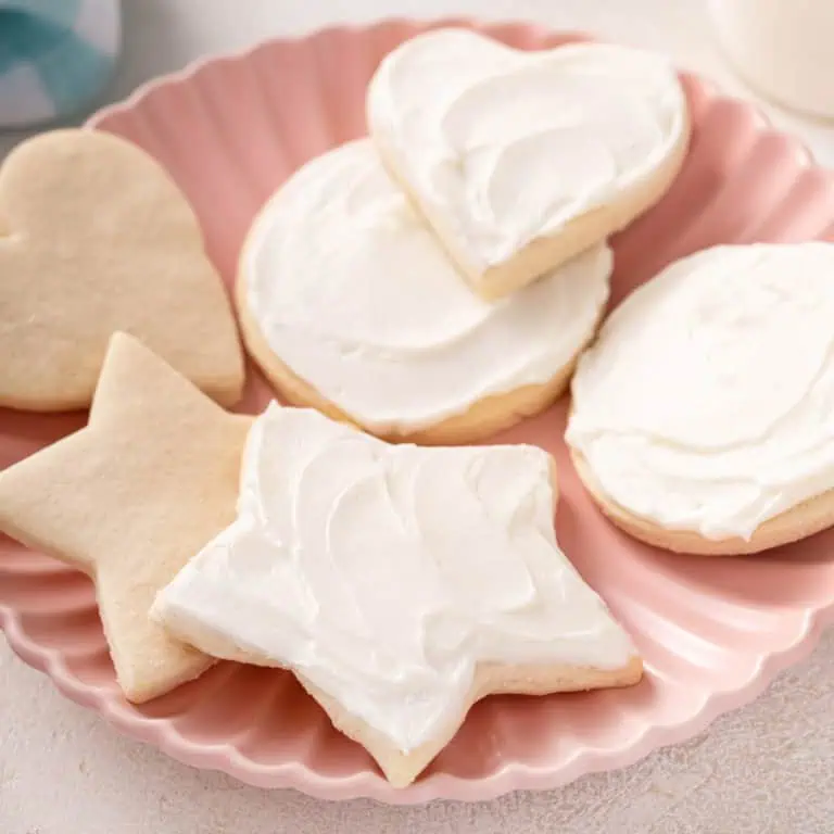 Several no chill sugar cookies on a pink plate.
