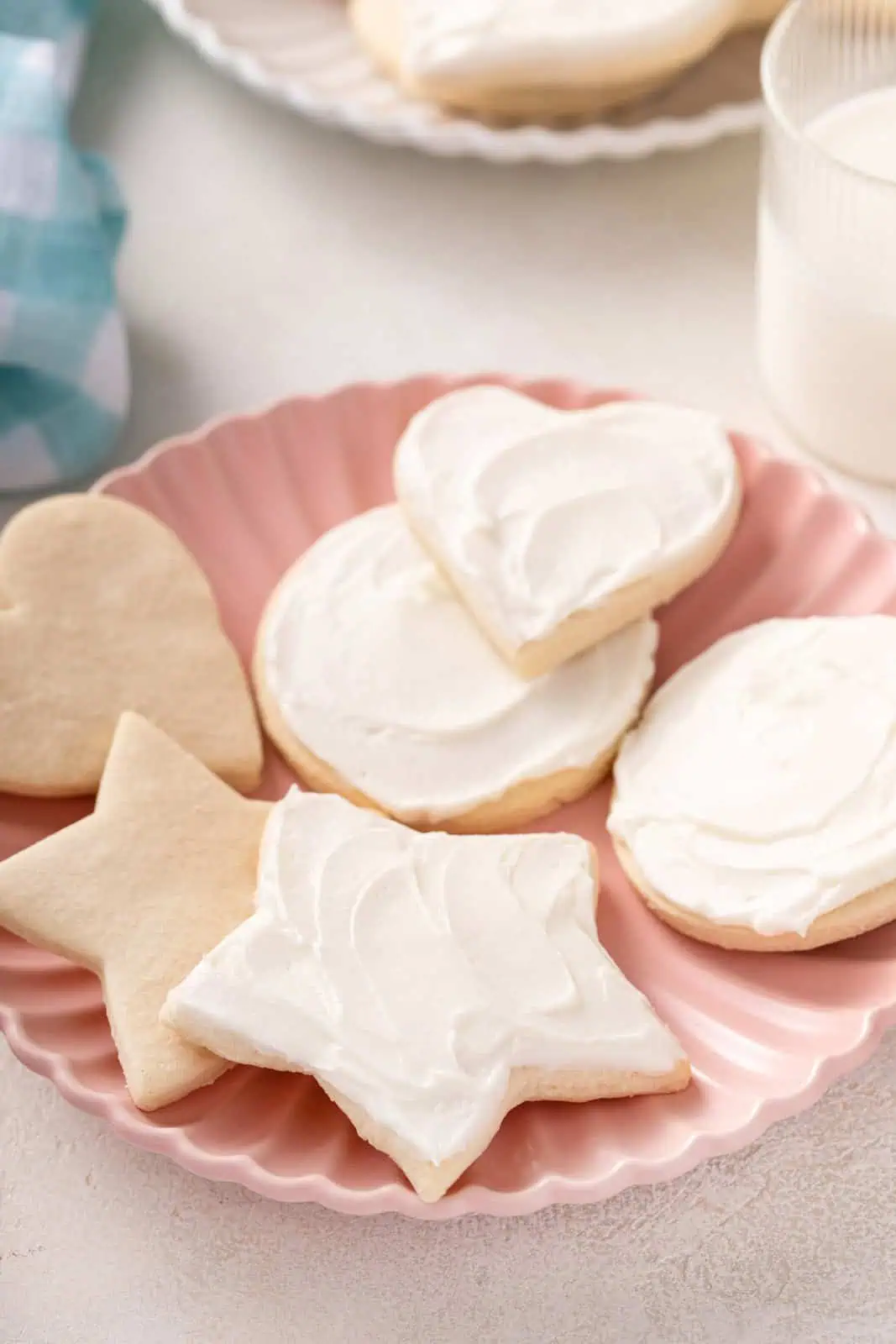 No chill sugar cookies in star, heart, and circle shapes on a pink plate.