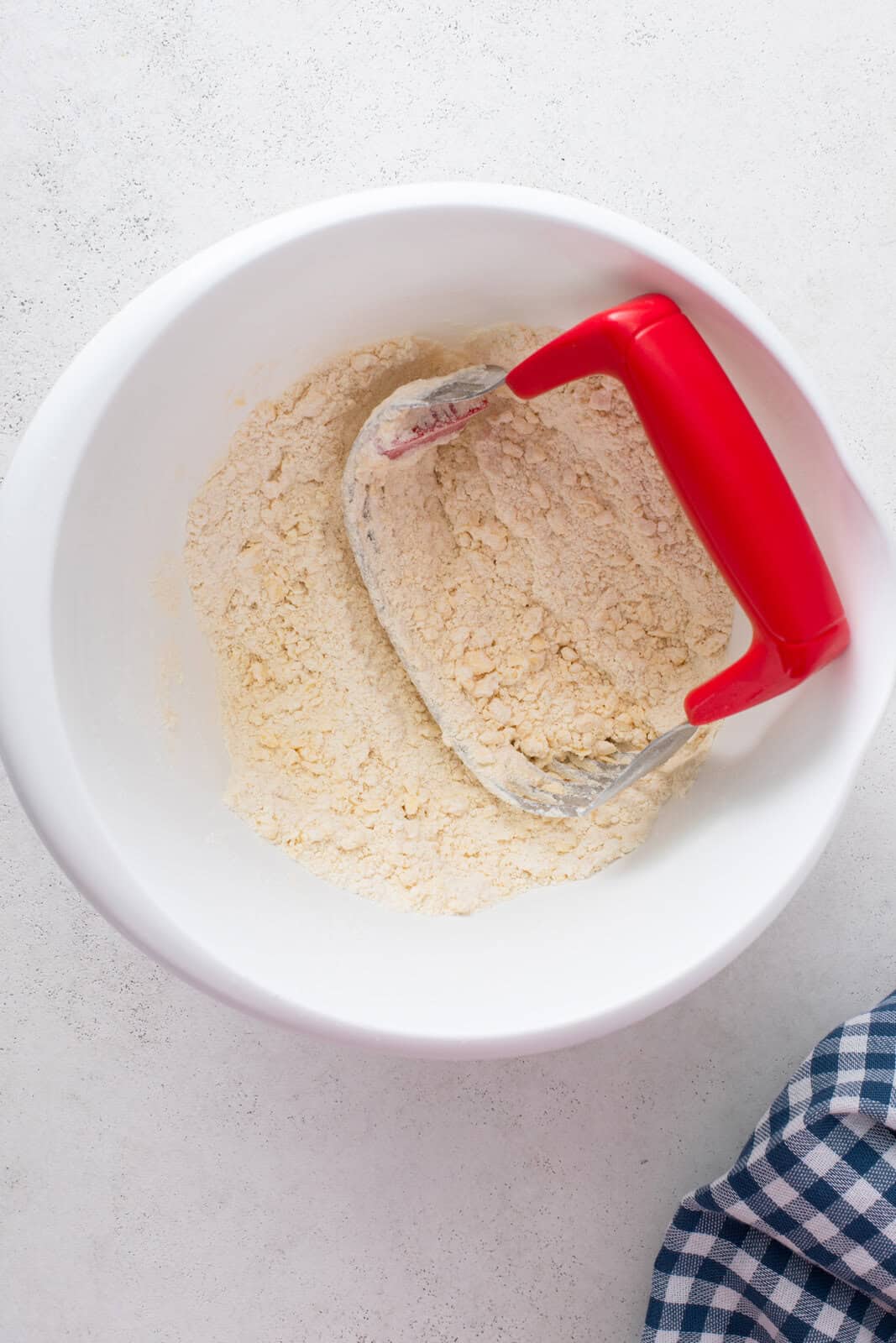 Pastry blender cutting shortening into dry ingredients.