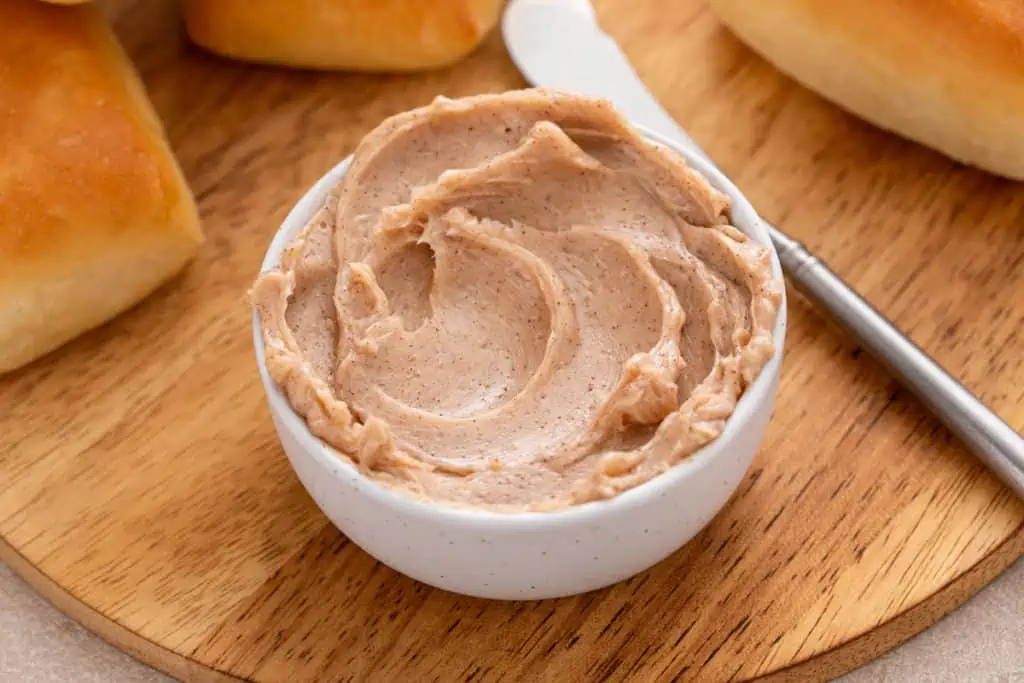 Close up of cinnamon honey butter in a white bowl.