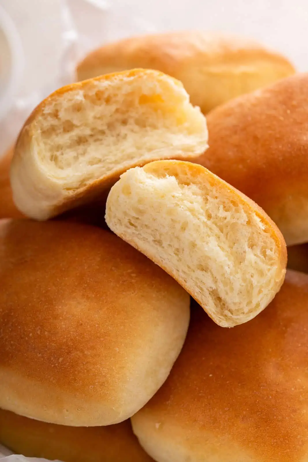 Close up of halved Texas roadhouse roll in a bread basket.