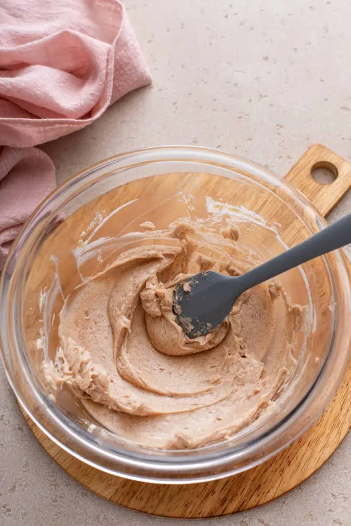 Cinnamon honey butter being mixing in a glass mixing bowl.