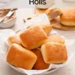 Close up of texas roadhouse rolls arranged in a bread basket on a beige countertop. Text overlay includes recipe name.