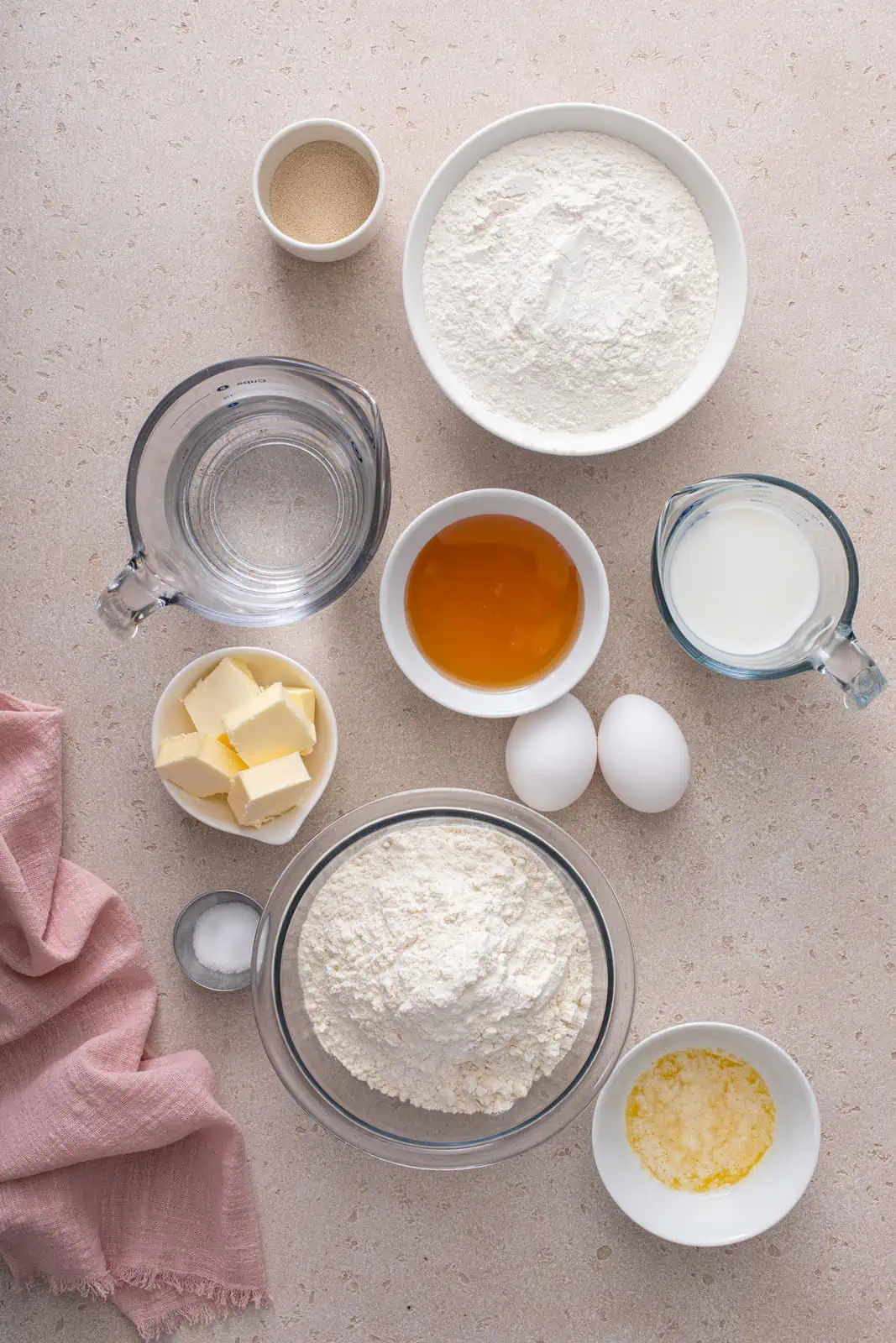 Ingredients for texas roadhouse rolls arranged on a gray countertop.