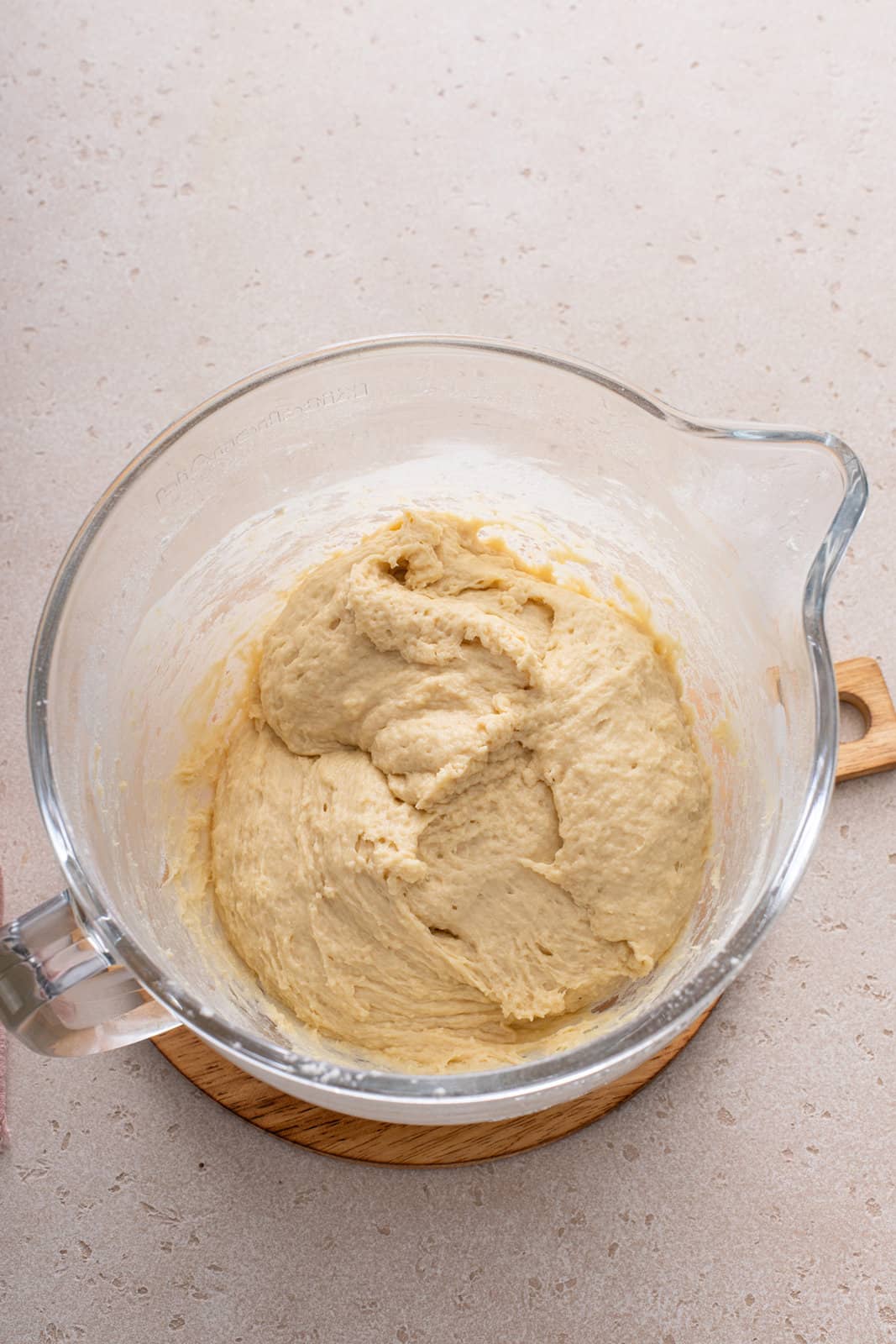 Unkneaded texas roadhouse roll dough in a mixing bowl.