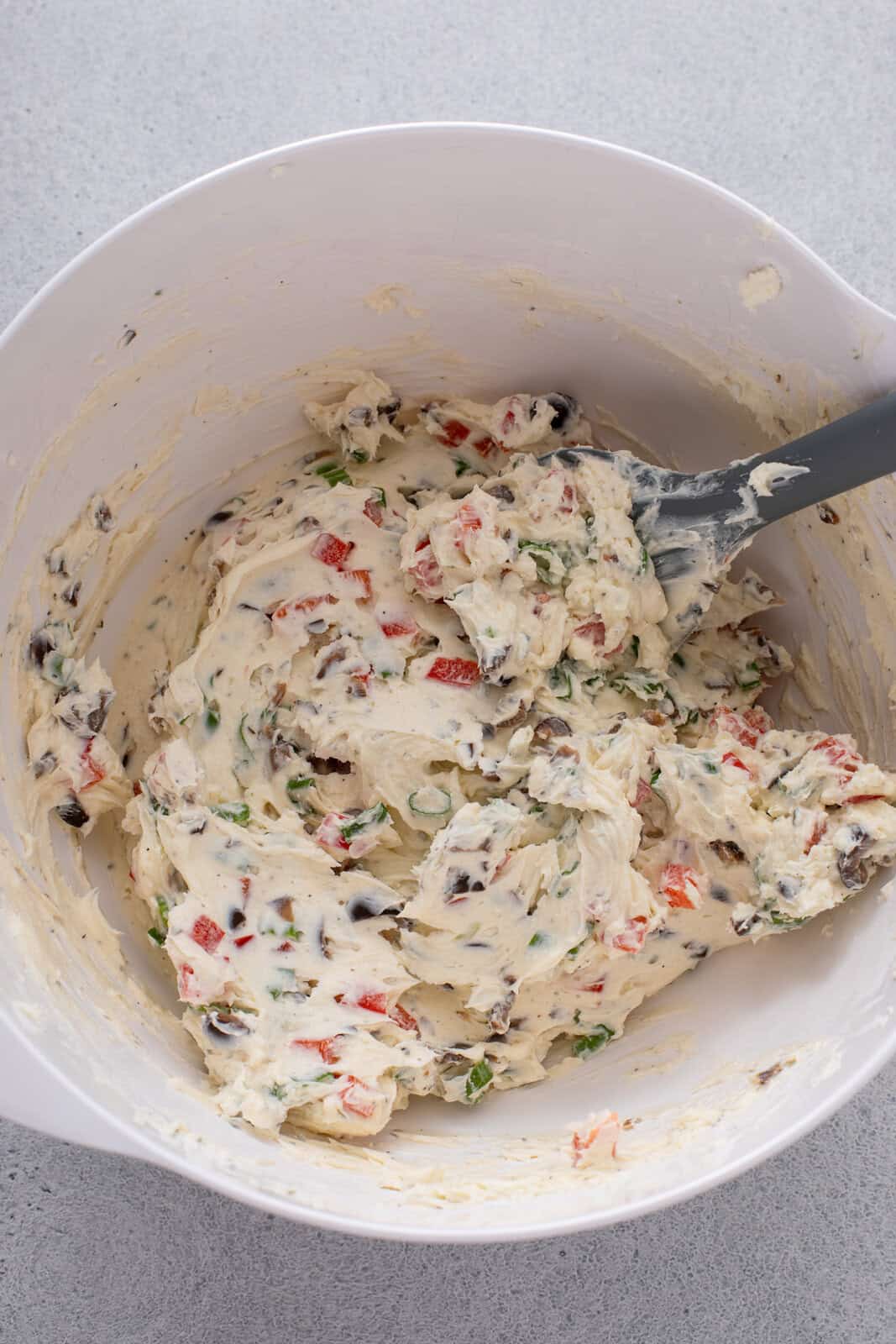 Filling for cream cheese ranch roll ups mixed in a white bowl.