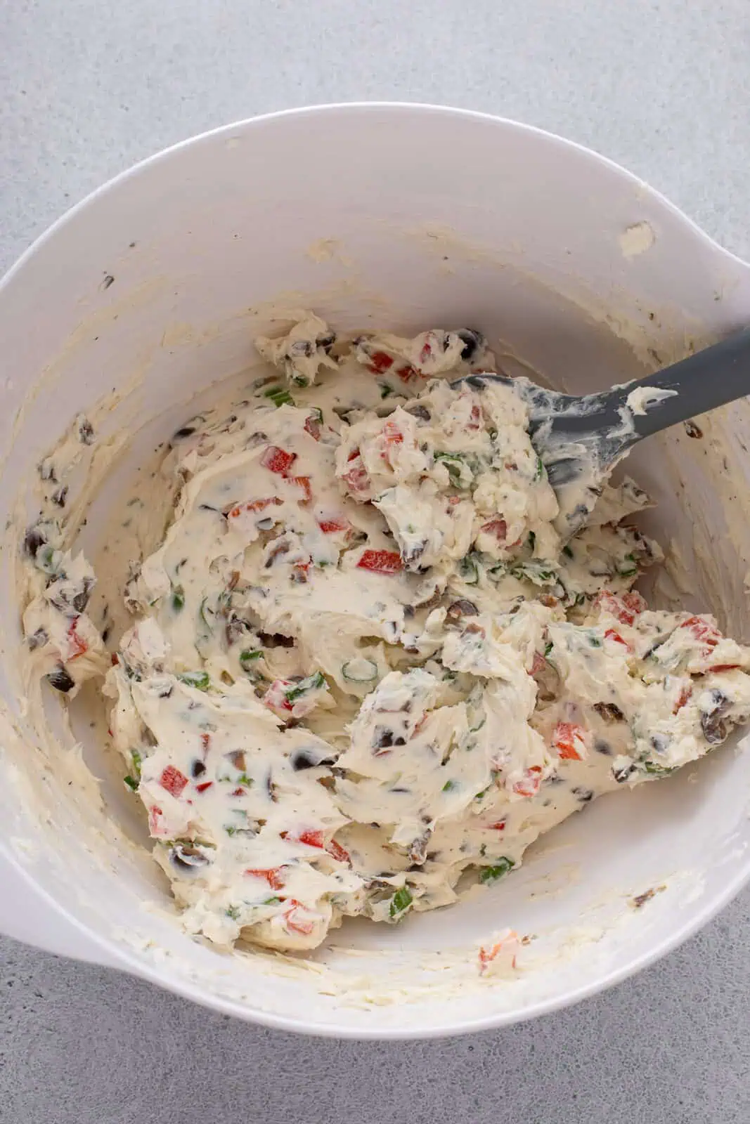 Filling for cream cheese ranch roll ups mixed in a white bowl.