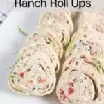 Close up of cream cheese pinwheels on a white platter. Text overlay includes recipe name.