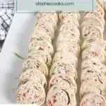 Rows of cream cheese ranch rollups on a white platter. text overlay includes recipe name.