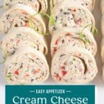 Cream cheese ranch roll ups arranged on a white platter, garnished with green onions. Text overlay includes recipe name.