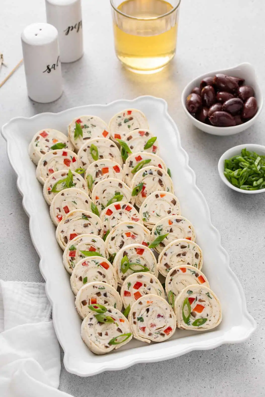 White platter filled with slices of cream cheese ranch roll ups.