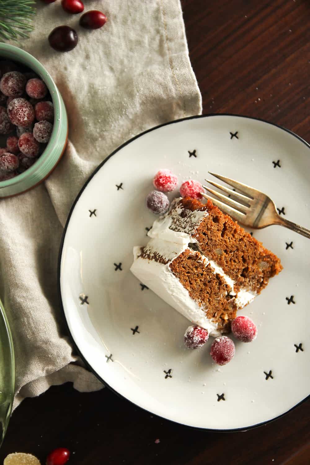 Gingerbread Layer Cake is garnished with sugared cranberries for a perfectly festive dessert