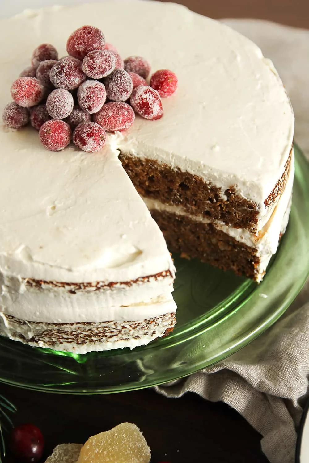 Gingerbread Layer Cake is two layers of gingerbread cake with whipped cream frosting and sugared cranberries