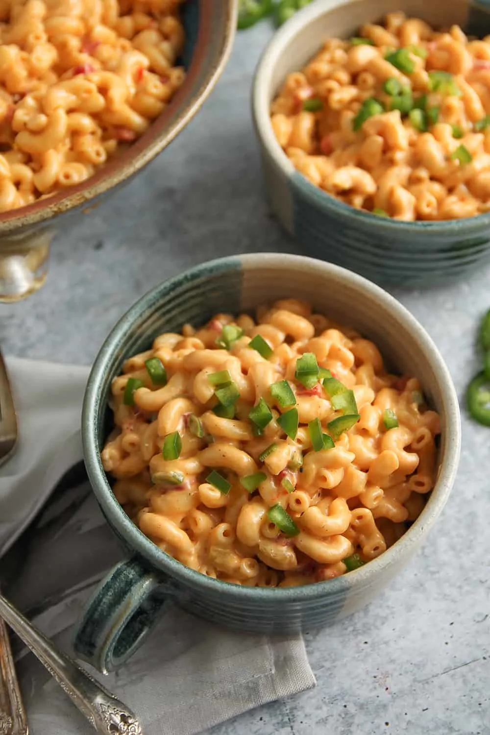 Bowl of macaroni and pimento cheese garnished with diced jalapenos