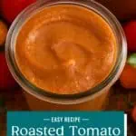 Overhead view of roasted tomato sauce in a glass jar. Text overlay includes recipe name.