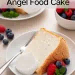 Two plated slices of angel food cake with whipped cream and fresh berries. Text overlay includes recipe name.