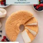 Overhead view of angel food cake on a cake plate, with half of the cake cut into slices. Text overlay includes recipe name.