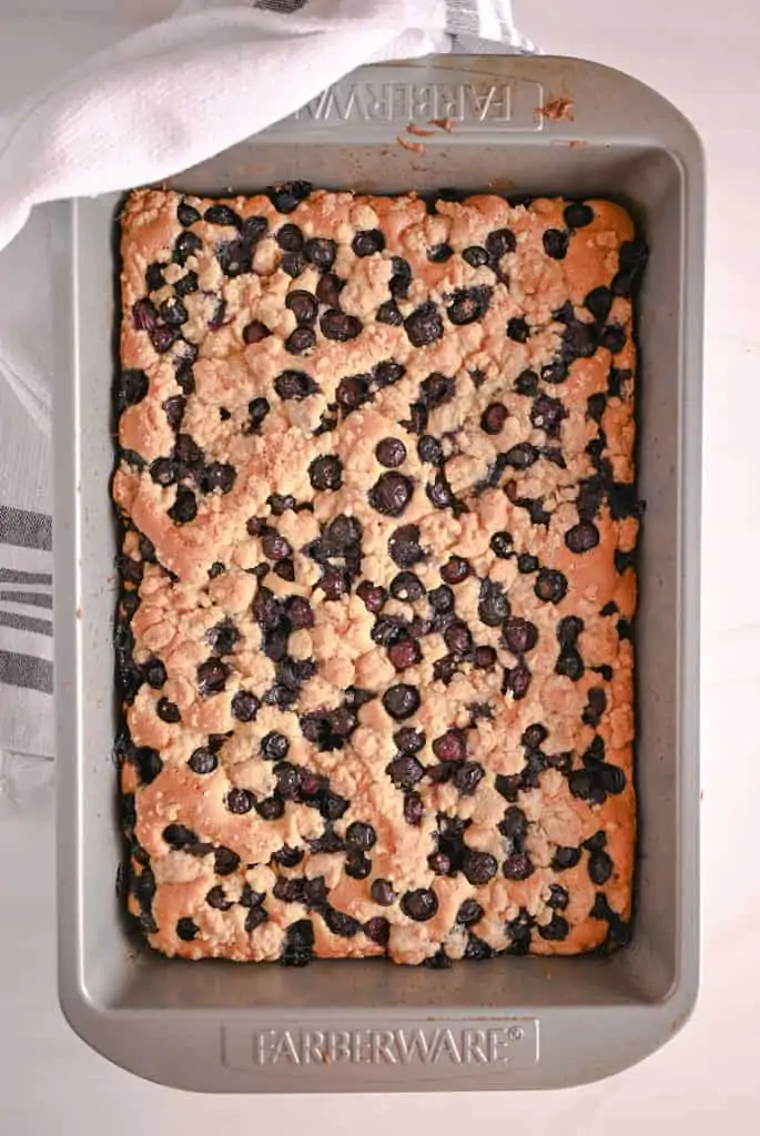 Baked blueberry crumb cake in a metal cake pan
