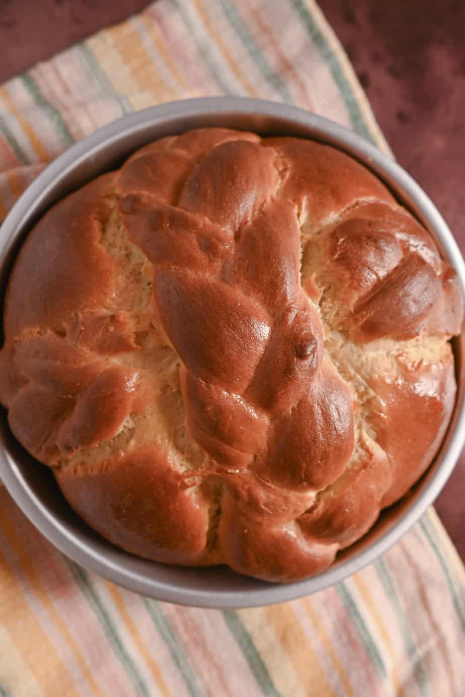 Overhead view of baked Paska loaf, decorated with crossed braids