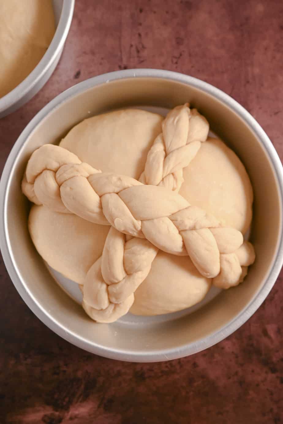 Paska decorated with crossed braids, ready to go in the oven to be baked