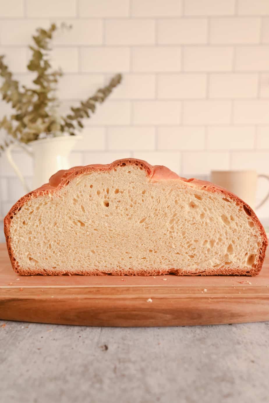 Halved loaf of paska on a cutting board, showing the inner crumb