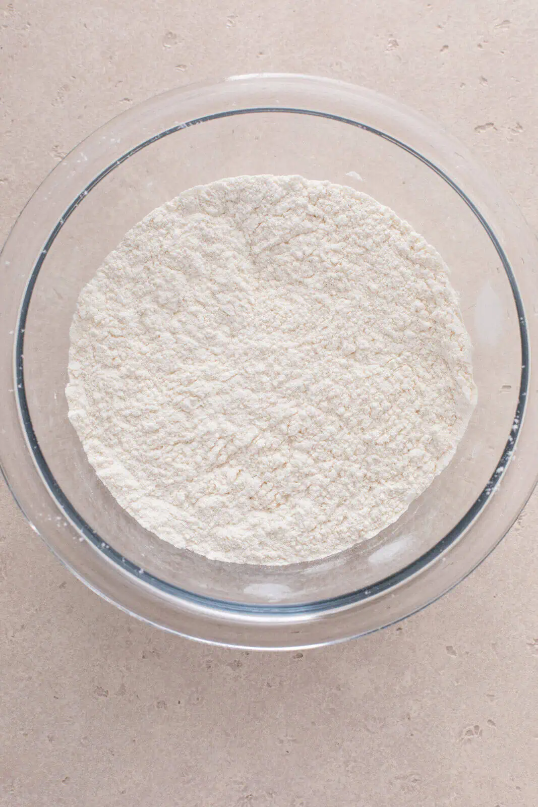 Cake flour and sugar sifted together in a bowl.