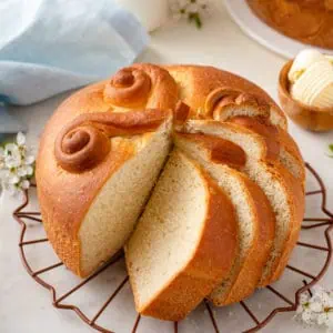 Sliced loaf of Paska on a wire rack.