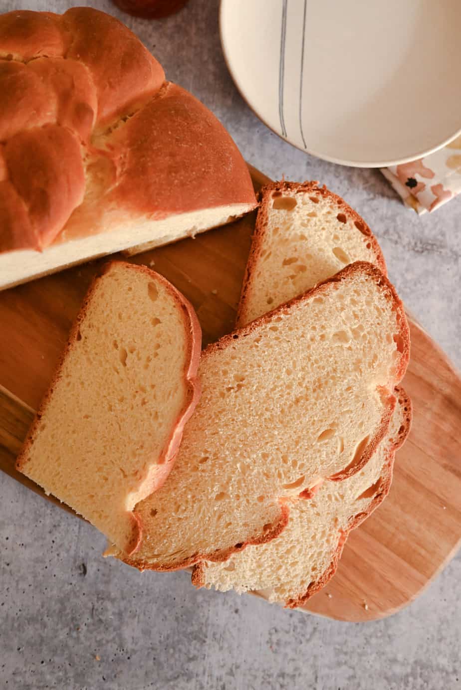 Sliced loaf of paska on a wooden cutting board