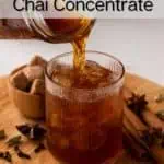 Homemade chai concentrate being poured over ice in a glass. Text overlay includes recipe name.