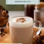 Glass mug filled with a hot chai latte and garnished with cinnamon set on a wooden board, with whole spices in the background. Text overlay includes recipe name.