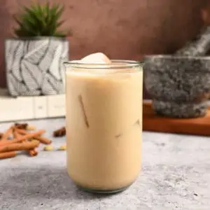 Glass of iced chai on a cement countertop