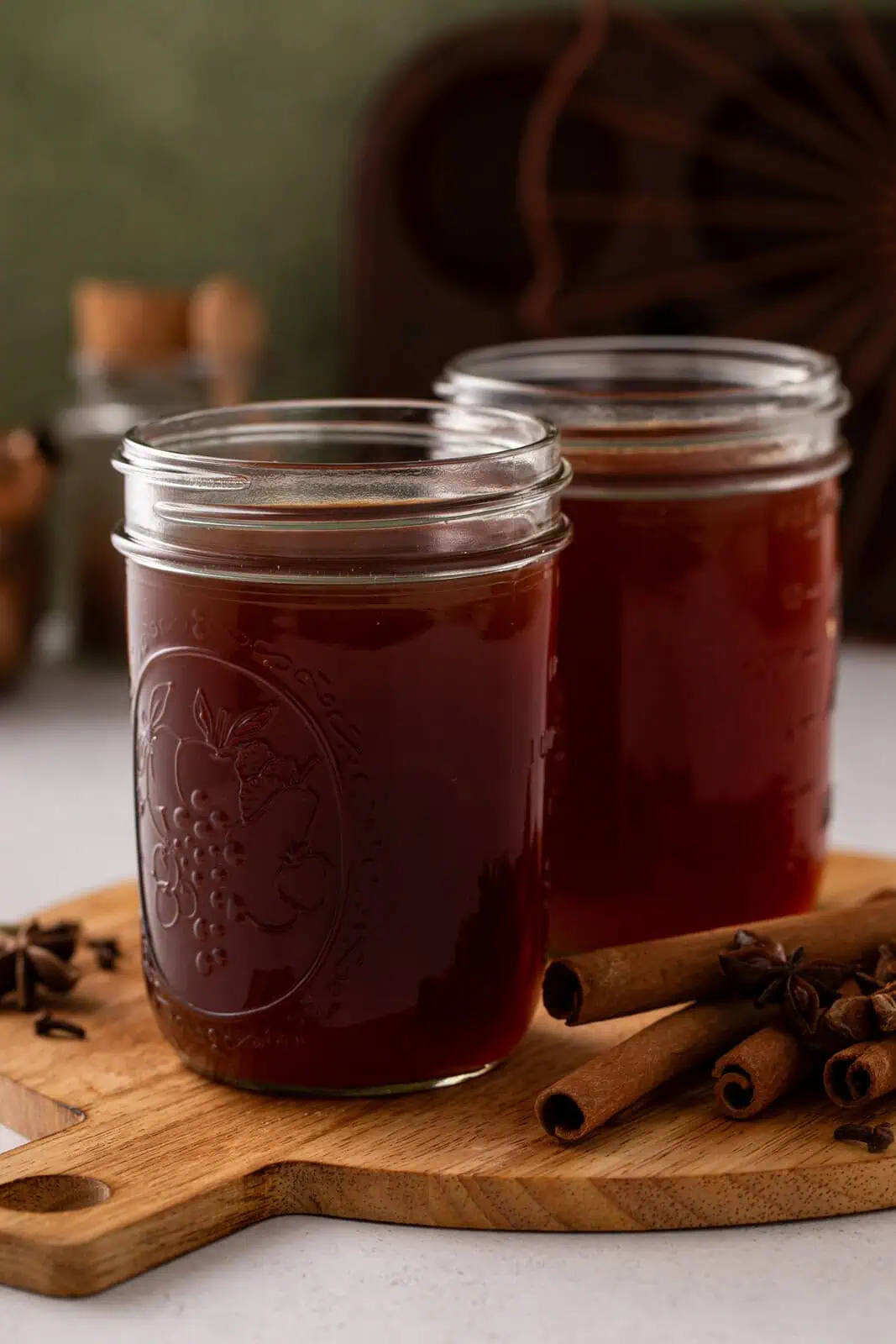 Two glass jars filled with homemade chai concentrate.