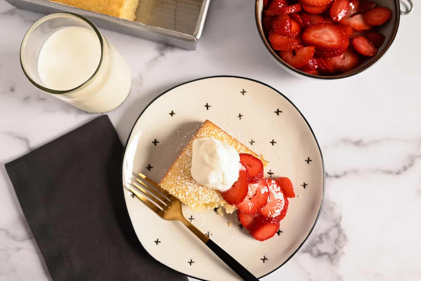 Overhead view of a slice of yellow cake with a bite taken from the corner.