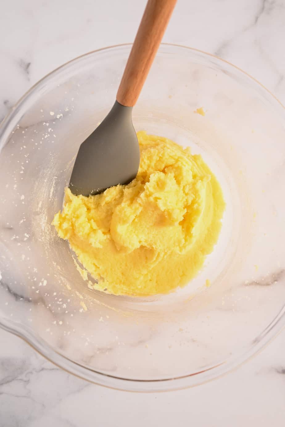 Wet ingredients for homemade yellow cake mixed in a glass mixing bowl.