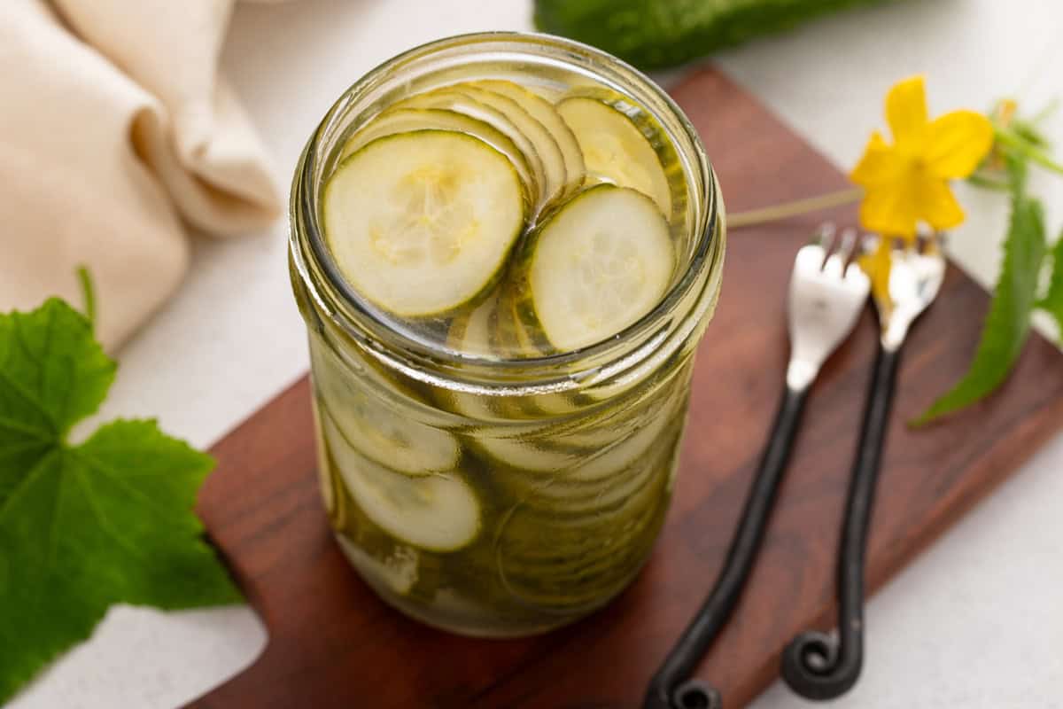 Brined pickled cucumbers in a glass jar.
