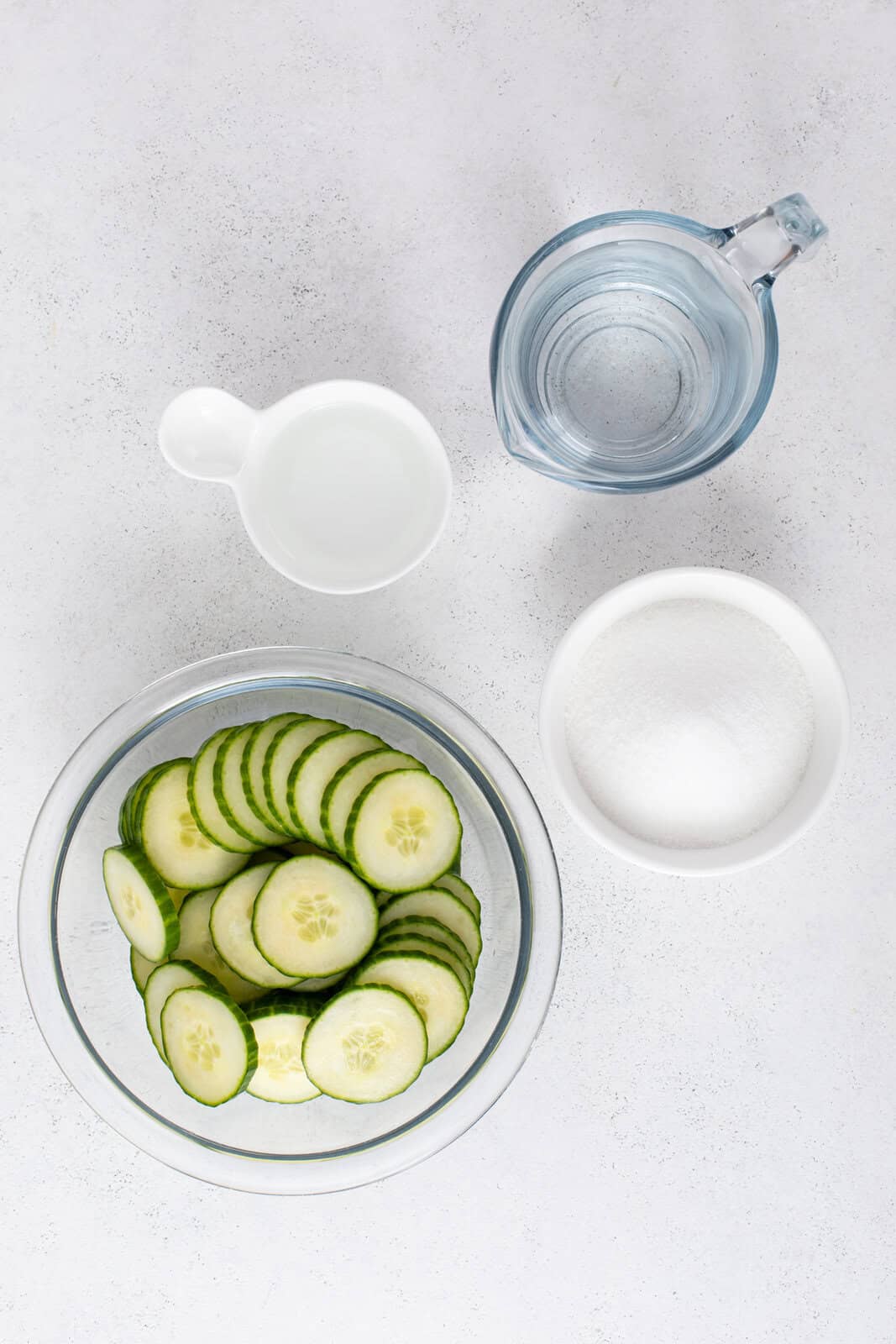 Pickled cucumber ingredients arranged on a countertop.