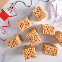 Several peanut butter rice krispie bars on a marble countertop.