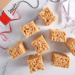 Several peanut butter rice krispie bars on a marble countertop.