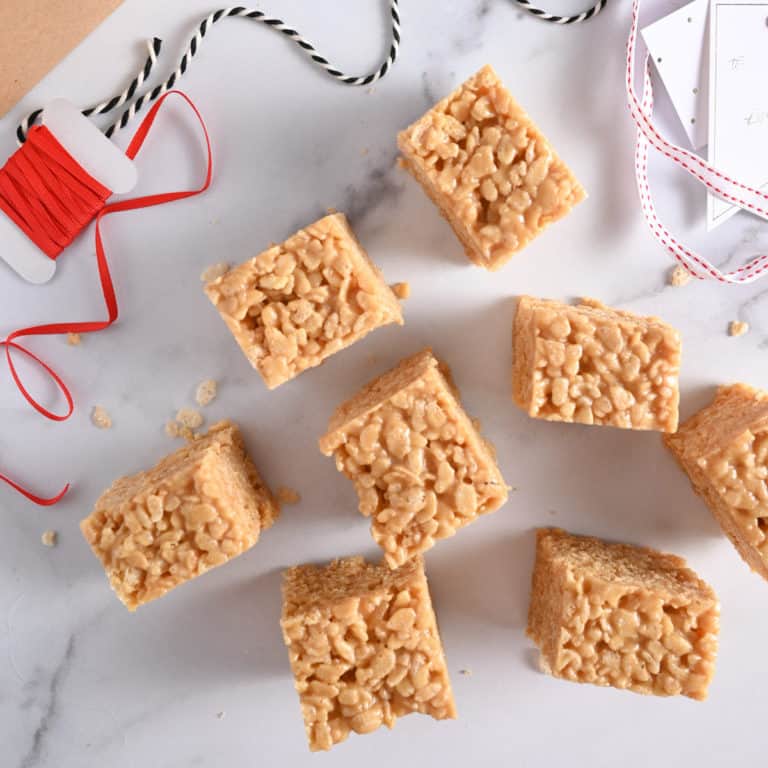 Several peanut butter rice krispie bars on a marble countertop.