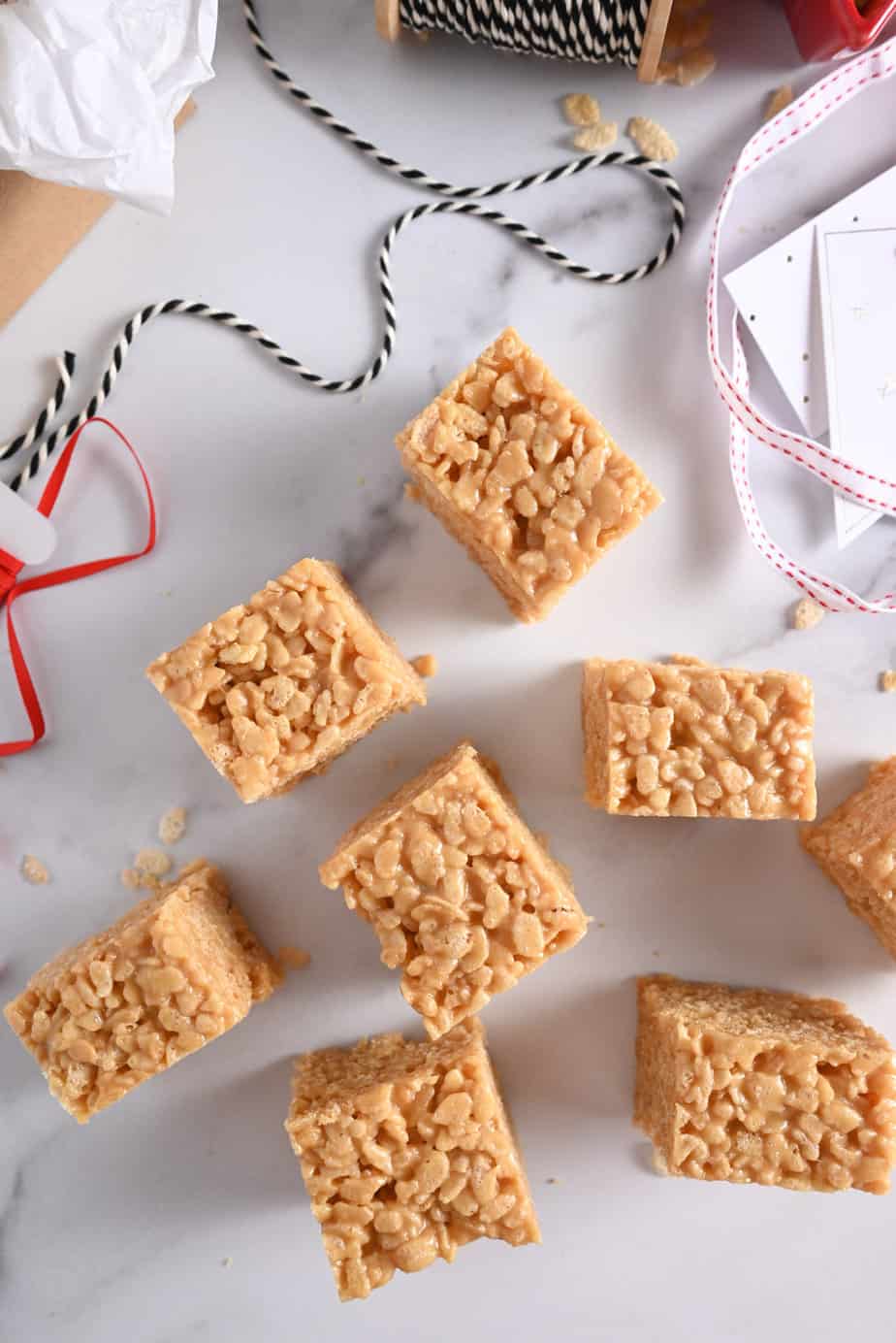 Close up of sliced peanut butter rice krispie bars on a marble countertop.