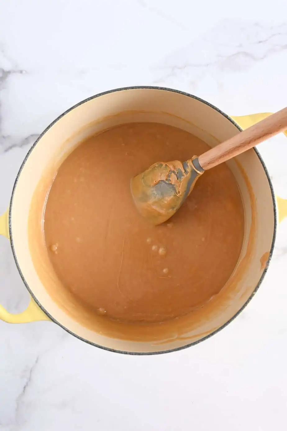 Peanut butter mixture for rice krispie bars in a large dutch oven.