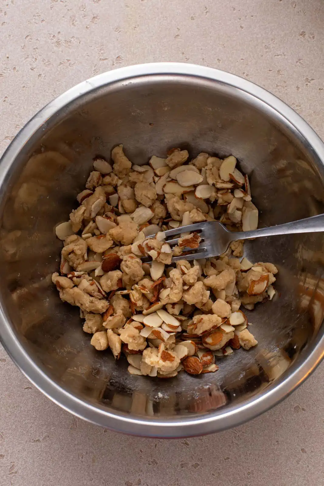 Almond topping for raspberry coffee cake in a metal bowl.